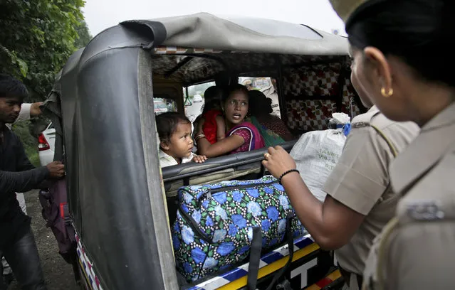 Indian policewomen question a woman passenger in an auto rickshaw as they check for supporters of the Dera Sacha Sauda sect near Panchkula, India, Thursday, August 24, 2017. (Photo by Altaf Qadri/AP Photo)
