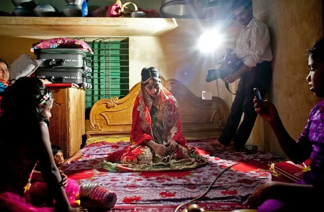 Nasoin Akhter, 15, poses for a video on the day of her wedding to a 32-year-old man, August 20, 2015, in Manikganj, Bangladesh. (Photo by Allison Joyce/Getty Images)