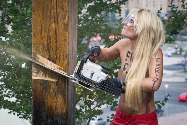 Ukraine FEMEN-activist Cuts Down Cross in Russian Female Punk Rock Band Protest