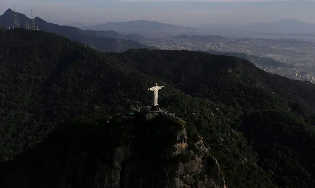 An aerial view shows the Christ the Redeemer atop the Corcovado mountain in Rio de Janeiro, Brazil, July 16, 2016. (Photo by Ricardo Moraes/Reuters)