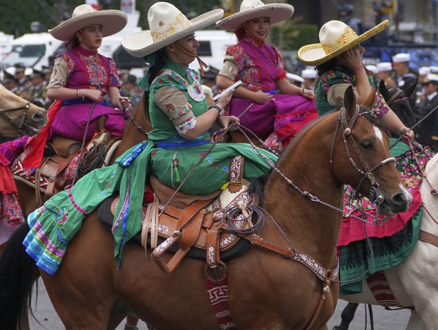 Amazonas dressed as Mexican Revolution-era fighters ride their horses in the annual Independence Day military parade in the capital's main square, the Zocalo, in Mexico City, Friday, September 16, 2022. (Photo by Marco Ugarte/AP Photo)