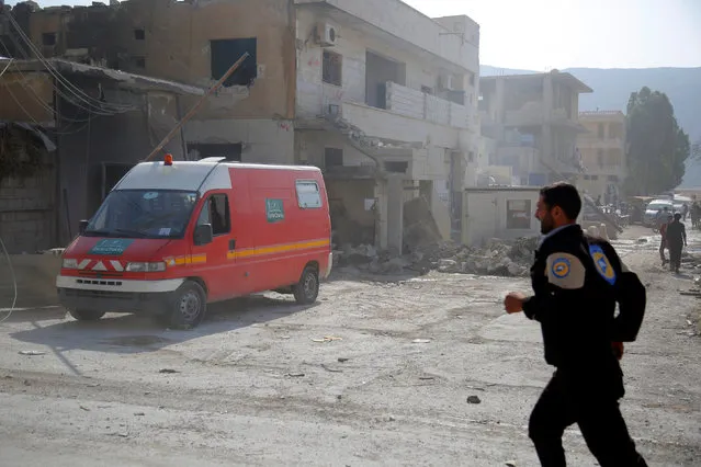 A civil defence member runs near an ambulance after an airstrike on a hospital in the town of Meles, western Idlib city in rebel-held Idlib province, Syria August 6, 2016. (Photo by Ammar Abdullah/Reuters)