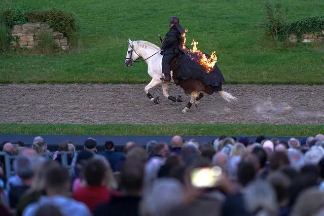 A performer on horseback reenacts a battle scene as he takes part in the season opening performance of Kynren – An Epic Tale of England, as 11 Arches open their season and present an immersive experience and various live action shows at Flatts Farm on August 06, 2022 in Bishop Auckland, England. The Kynren performance takes the audience on a journey through 2,000 years of English history as seen through the eyes of Arthur, a 10-year old boy from the North East who encounters rebellions, wars, magic, majesty, celebration and heartache from Boudicca’s battles with the Romans to two world wars, via Vikings, Tudors and the fate of Charles I. The outdoor-theatre event involves more than 1,000 volunteers from the local area as the cast and crew who have all been professionally trained. (Photo by Ian Forsyth/Getty Images)