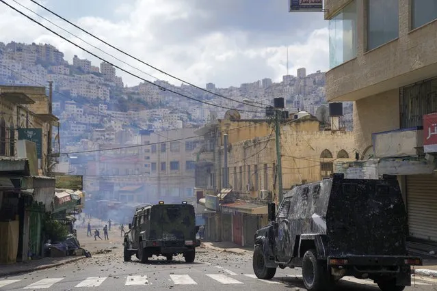 Palestinians clash with Palestinian security forces following an arrest raid against local militants, in the West Bank city of Nablus Tuesday, September 20, 2022. (Photo by Nasser Nasser/AP Photo)
