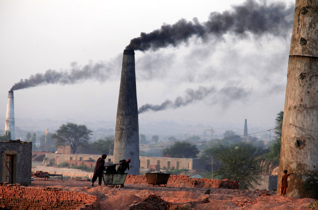 Smoke rises from the smoke stacks of brick factories on the outskirts of Islamabad, Pakistan June 8, 2017. (Photo by Faisal Mahmood/Reuters)