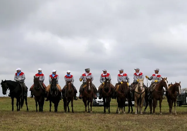 Participants line up before the start of the Russian Rodeo in the village of Kotliakovo, Bryansk region, southeast of Moscow, Russia, September 12, 2015. (Photo by Maxim Shemetov/Reuters)