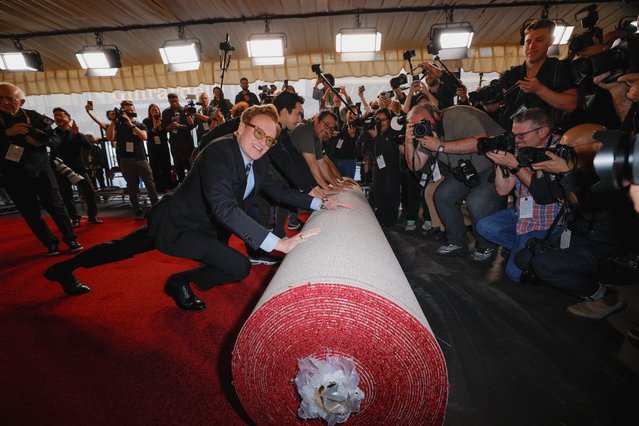 Academy Awards host Conan O'Brien pushes the rolled red carpet during its rollout for the 97th Academy Awards in Los Angeles, California, U.S., February 26, 2025. (Photo by Mike Blake/Reuters)