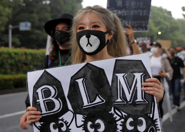 People wearing face masks march during a Black Lives Matter protest following the death in Minneapolis police custody of George Floyd, in Tokyo, Japan on June 14, 2020. (Photo by Kim Kyung-Hoon/Reuters)