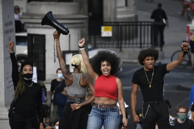 People chant slogans during a march at Trafalgar Square in central London, Saturday, June 20, 2020, organised by Black Lives Matter, in the wake of the killing of George Floyd by police officers in Minneapolis, USA last month that has led to anti-racism protests in many countries calling for an end to racial injustice. Anti-racism demonstrators are holding a fourth weekend of protests across the U.K. (Photo by Alberto Pezzali/AP Photo)