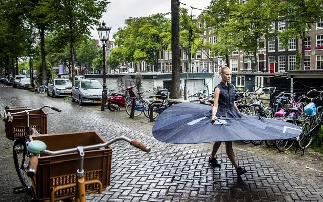 Ballerina Kira Hilli of the Netherlands National Ballet dances in a tutu with a diameter of 3 meters for a video made for the 1.5 meter society, on the Prinsengracht in Amsterdam, The Netherlands, 04 June 2020 (issued on 12 June 2020). The so-called social distance tutu is made of denim fabric, specially made for the Safe Distance Ballet. (Photo by Remko de Waal/EPA/EFE)