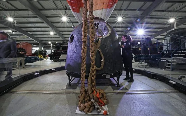 Claire Madley from the National Railway Museum Shildon in County Durham, England inspects on November 22, 2017 the Soyuz TMA-19M spacecraft which astronaut Tim Peake travelled back to earth from the International Space Station in, as it goes on display at the museum. (Photo by Owen Humphreys/PA Images via Getty Images)