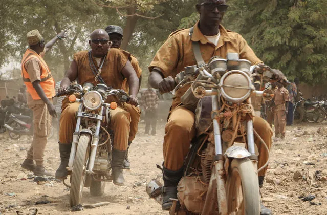 A group of local defense force fighters drive their motorbikes during an event to inaugurate a new chapter of the group in Ouagadougou, Burkina Faso, Saturday, March 14, 2020. In an effort to combat rising jihadist violence, Burkina Faso’s military has recruited volunteers to help it fight militants. (Photo by Sam Mednick/AP Photo)