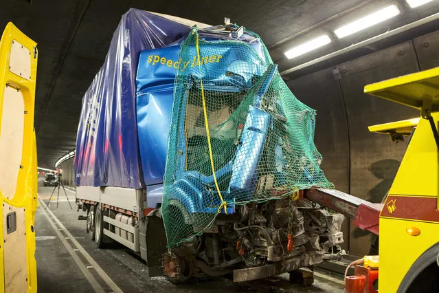 The wreckage of a truck stands in the Gotthard Tunnel near the village Hospental, Switzerland, Wednesday, December 13, 2017. Police say a head-on collision between a car and the truck in the tunnel has left two people dead and forced the temporary closure of the tunnel, a key transit route through the Alps. (Photo by Alexandra Wey/Keystone via AP Photo)