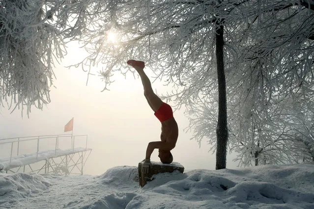 This picture taken on January 17, 2013 shows 77-year-old retired teacher Gao Yinyu exercising in his underwear at a snow-covered bathing spot in Jilin, in northeastern China's Jilin province, in a temperature of minus 25 degrees Celsius. Gao has been exercising in only his underwear every morning for more than the past decade and has rarely caught cold ever since retirement. (Photo by AFP Photo)