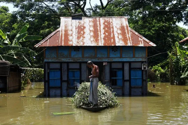 A man is seen on a boat after his house was flooded, after the flood situation worsened in Munshiganj district, on the outskirts of Dhaka, Bangladesh, July 25, 2020. (Photo by Mohammad Ponir Hossain/Reuters)