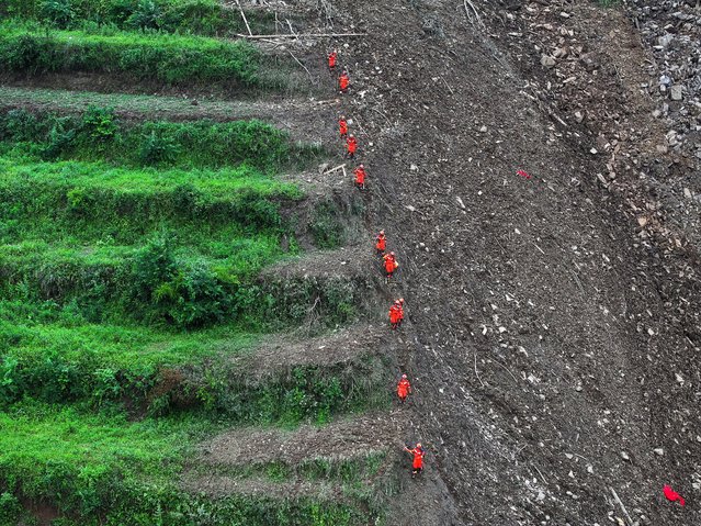 Rescuers at work following a landslide in Qingyang, in Dafang County of Bijie City, southwest China's Guizhou Province, 22 May 2025. A landslide struck Guowa township trapping 19 persons, two bodies having retrieved so far. (Photo by Yang Wenbin/Xinhua News Agency)