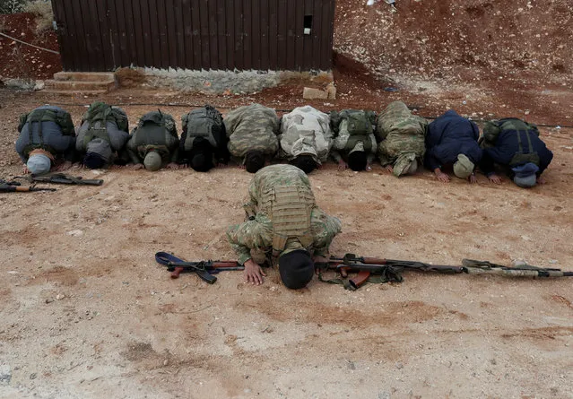 Turkey-backed Free Syrian Army fighters pray at a training camp in Azaz, Syria January 21, 2018. (Photo by Osman Orsal/Reuters)