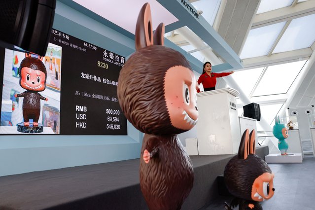 An auctioneer takes bids from buyers for a Labubu figurine, during an auction by Yongle International Auction in Beijing, China on June 10, 2025. (Photo by Tingshu Wang/Reuters)