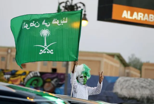 A man waves a flag as people celebrate Saudi Arabia's 90th annual National Day, amid the spread of the coronavirus disease (COVID-19) in Riyadh, Saudi Arabia on September 23, 2020. (Photo by Ahmed Yosri/Reuters)