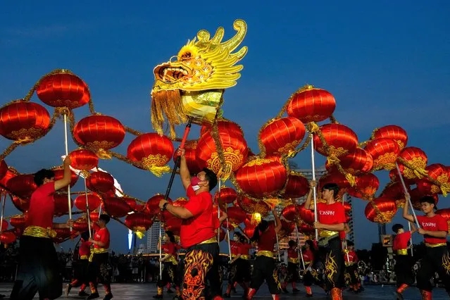 A dragon dance performance is seen ahead of the Lunar New Year celebration in Bangkok, Thailand on January 18, 2023. (Photo by Athit Perawongmetha/Reuters)