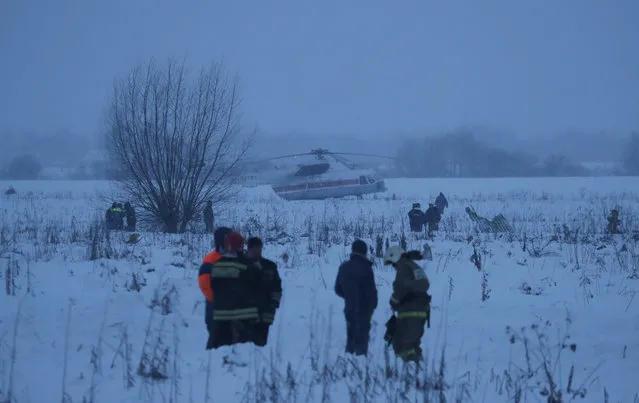 Emergency services work at the scene where a short-haul regional Antonov AN-148 plane crashed after taking off from Moscow's Domodedovo airport on February 11, 2018. A Russian passenger plane carrying 71 people crashed Sunday near Moscow, killing everyone aboard shortly after the jet took off from one of the city' s airports. (Photo by Maxim Shemetov/Reuters)