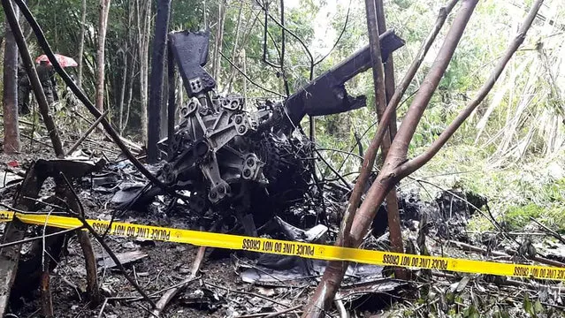In this photo provided by the Lantawan Disaster Risk Reduction Management Office, the remains of a Philippine air force S-76A Sikorsky helicopter after it crashed in Basilan island, southern Philippines on Wednesday September 16, 2020. The helicopter was en route to airlift troops wounded from a recent suicide bombing crashed on a southern island Wednesday, killing all four crew members on board, officials said. (Photo by Lantawan Disaster Risk Reduction Management Office via AP Photo)