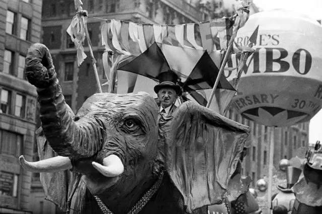 Comedian Jimmy Durante rides on a Jumbo the elephant float during the annual Macy's Thanksgiving Day Parade in New York City on November 22, 1962. (Photo by AP Photo)