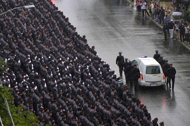 New York Police officers salute as the hearse carrying the casket of NYPD officer Didarul Islam passes after his funeral, Thursday, July 31, 2025, in New York. (Photo by Yuki Iwamura/AP Photo)