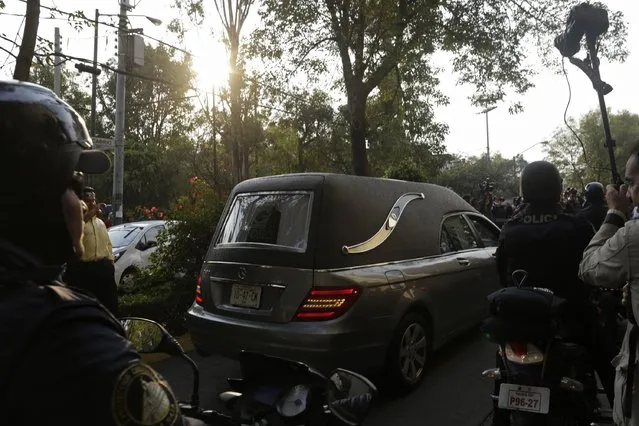 A funeral van with the body of Mexican actor and screenwriter Roberto Gomez Bolanos arrives at Mexican media company Televisa in Mexico City November 29, 2014. (Photo by Carlos Jasso/Reuters)