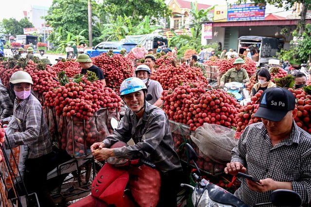 Vietnamese farmers transport harvested lychees to sell to traders at a wholesale market in Luc Ngan district of Vietnam's Bac Giang province on June 18, 2025. (Photo by Nhac Nguyen/AFP Photo)