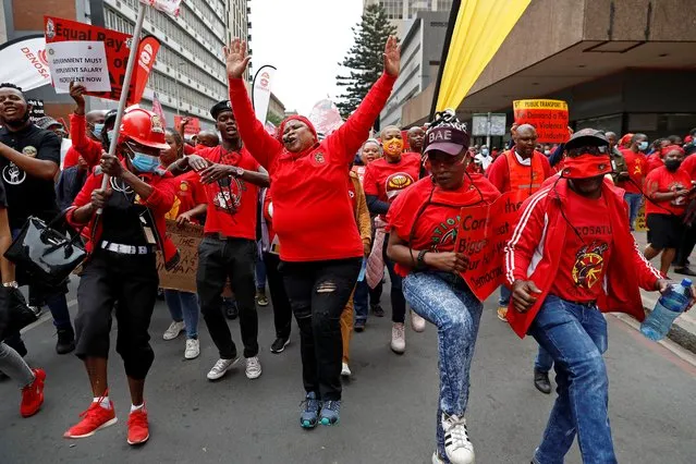 Members of Congress of South African Trade Unions (Cosatu) chant while marching to the National Treasury during their national strike against corruption and unemployment in Pretoria on 07 October, 2020. (Photo by Phill Magakoe/AFP Photo)