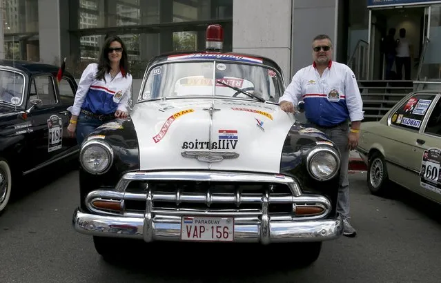 Participants pose with their 1951 Chevrolet Bell Air before participating in the 25th edition of the "1000 millas sport e historicos" (1000 miles sports and classic) race in Montevideo, October 28, 2015. The race will cover 1000 miles from 28 to 31 of October.  REUTERS/Andres Stapff