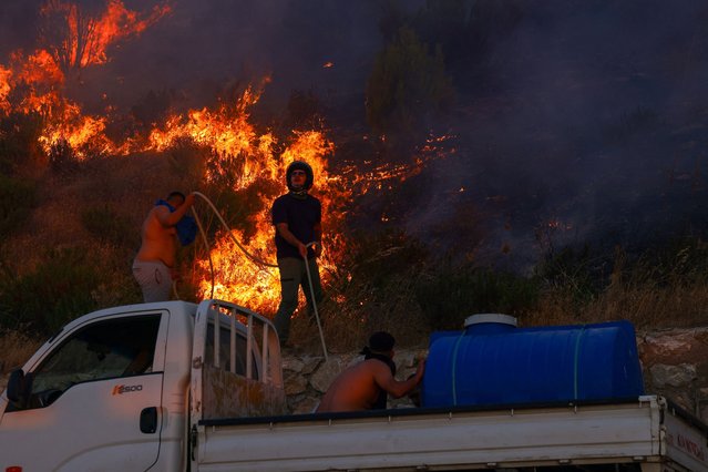People try to extinguish a wildfire in the northwestern city of Canakkale province, Turkey, on August 11, 2025. (Photo by Dilara Senkaya/Reuters)