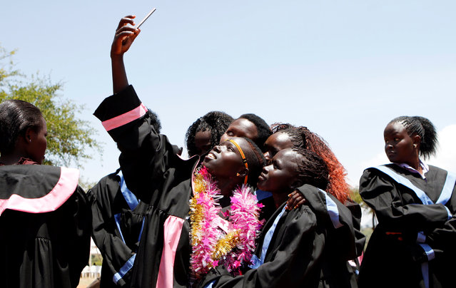 Pokot community girls who escaped from Female Genital Mutilation and forced early marriages take a selfie before their graduation ceremony after completing trainings on social entrepreneurship and information and communications technology (ICT) at the St. Elizabeth girls centre in Ortum, West Pokot county, Kenya, September 15, 2016. (Photo by Reuters/Stringer)