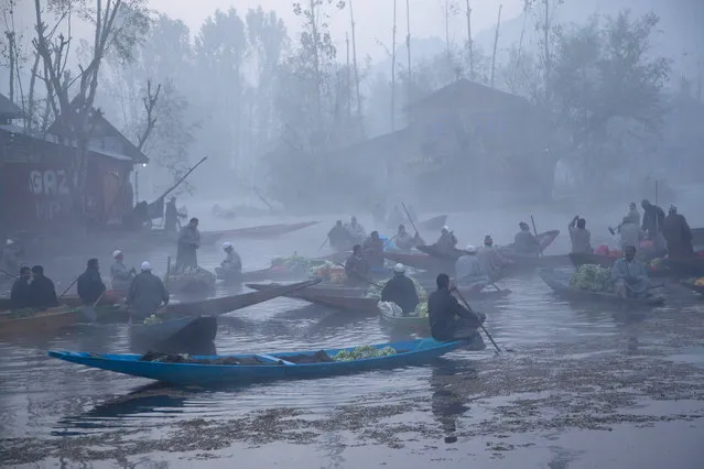 Kashmiri men sell their produce at the floating vegetable market on the Dal Lake surrounded by dense fog on a cold morning in Srinagar, Indian controlled Kashmir, Wednesday, October 28, 2015. Vegetables traded in the floating market are supplied to Srinagar and many towns across the Kashmir valley. (Photo by Dar Yasin/AP Photo)