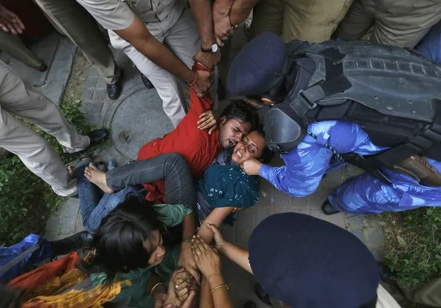 Police try to detain supporters of Aam Aadmi Party during a protest outside the residence of India's Prime Minister Manmohan Singh in New Delhi April 21, 2013. Angry crowds demonstrated in the capital on Saturday after a five-year-old girl was allegedly raped, tortured and kept in captivity for 40 hours, reviving memories of last December's brutal assault on a woman that shook the country. (Photo by Adnan Abidi/Reuters)