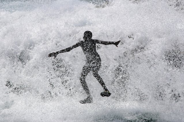 A child plays with waves as he and others enjoy the morning at a public beach in Mogadishu, Somalia, Monday, September 15, 2025. (Photo by Farah Abdi Warsameh/AP Photo)