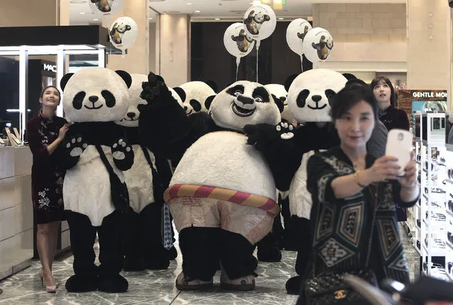In this Thursday, April 28, 2016 file photo, a woman takes a selfie with workers wearing panda costumes during a promotion event for Chinese tourists at a department store in Seoul, South Korea. Chinese anger at South Korea over its decision to deploy an U.S. anti-missile defense system appears to be threatening everything from appearances by the stars of K-Pop to future cooperation on North Korea at the United Nations. (Photo by Ahn Young-joon/AP Photo)
