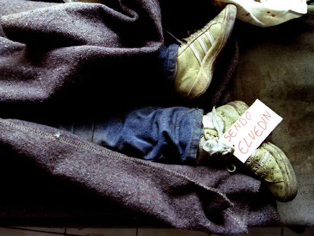 The feet of a 10 year old Bosnian Muslim boy Elvedin Sendo, clad in grass-stained running shoes and marked with his name tag, protrude from under a blanket at a hospital morgue after his school came under a shelling attack in Sarajevo in a March 22, 1993 file photo.  Bosnian Serb wartime general Ratko Mladic was arrested in Serbia on May 26, 2011 after years on the run from international genocide charges, opening the way for the once-pariah state to approach the European mainstream. Mladic, accused of orchestrating the massacre of 8,000 Muslim men and boys in the town of Srebrenica and a brutal 43-month siege of Sarajevo during Bosnia's 1992-5 war, was found in a farmhouse owned by a cousin, a police official said. (Photo by Chris Helgren/Reuters)