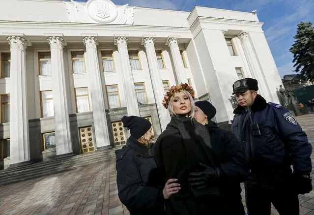 Ukrainian police detain an activist of women's rights group Femen as she protests against homophobia outside the parliament building in Kiev, Ukraine, November 12, 2015. (Photo by Gleb Garanich/Reuters)