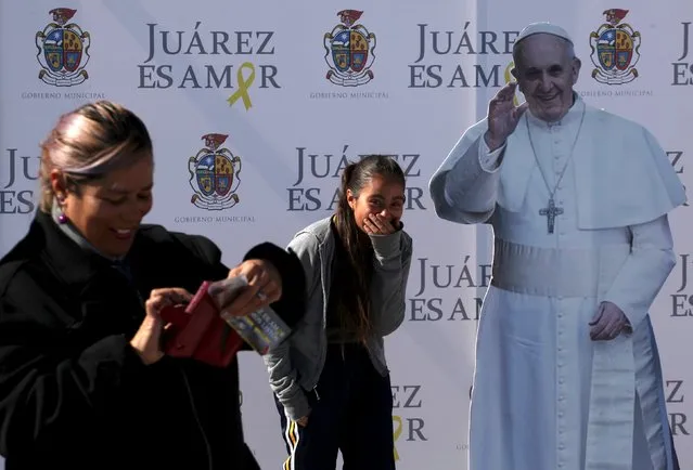 A girl reacts while standing next to a Pope Francis cardboard cut-out placed by the local government in Ciudad Juarez, Mexico, November 19, 2015. Pope Francis will visit Mexico on February 2016, local media reported. (Photo by Jose Luis Gonzalez/Reuters)