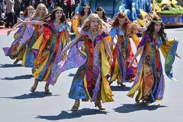 Performers take part in a new daytime parade to mark the 40th anniversary of Tokyo Disneyland in Urayasu, in suburban Tokyo on April 10, 2023. (Photo by Richard A. Brooks/AFP Photo)