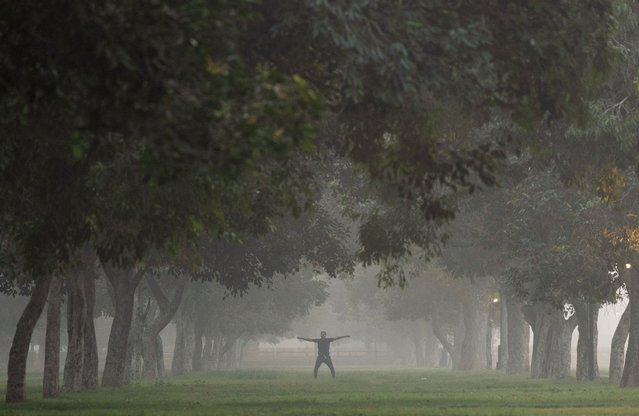 A man exercises at a park on a smoggy morning in New Delhi, India on October 31, 2025. (Photo by Adnan Abidi/Reuters)