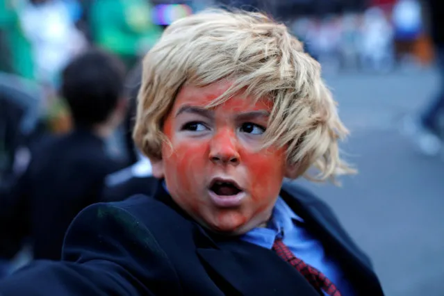 A boy dressed as a Republican U.S. presidential nominee Donald Trump marches in the annual Nyack Halloween Parade in the Village of Nyack, New York, U.S., October 29, 2016. (Photo by Mike Segar/Reuters)