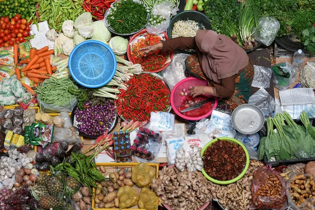 A woman sells vegetables at a wet market in Kota Bharu, in Malaysia's northeastern state of Kelantan on April 22, 2018. (Photo by Reuters/Stringer)