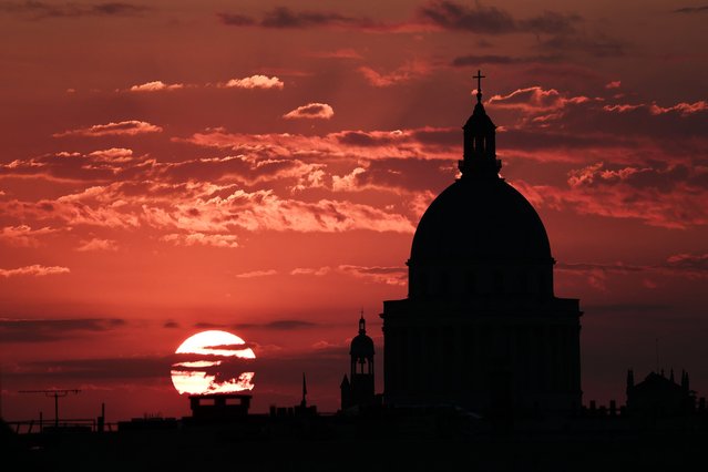 The sun rises behind the Pantheon in Paris on August 27, 2025. (Photo by Thibaud Moritz/AFP Photo)