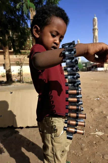 A boy holds bullet cartridges as clashes between Sudan's paramilitary Rapid Support Forces (RSF) and the army continue, in Khartoum North, Sudan on May 13, 2023. (Photo by Mohamed Nureldin Abdallah/Reuters)