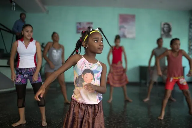 Sakia Corona, 8, (C) takes part in a rehearsal of the Contemporary Haitian Dance in a communal center in downtown Havana January 30, 2015. (Photo by Alexandre Meneghini/Reuters)