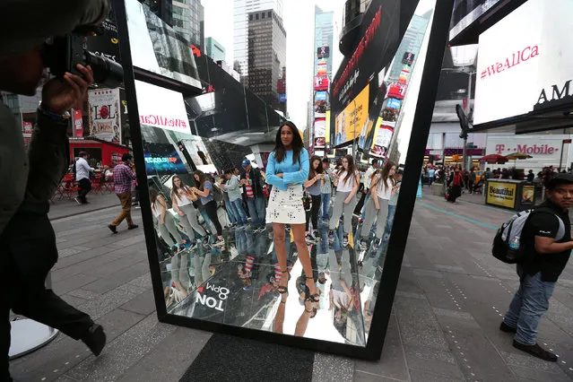 A woman poses for photos between mirrors in Times Square in the Manhattan borough of New York, New York, U.S., October 20, 2016. (Photo by Carlo Allegri/Reuters)