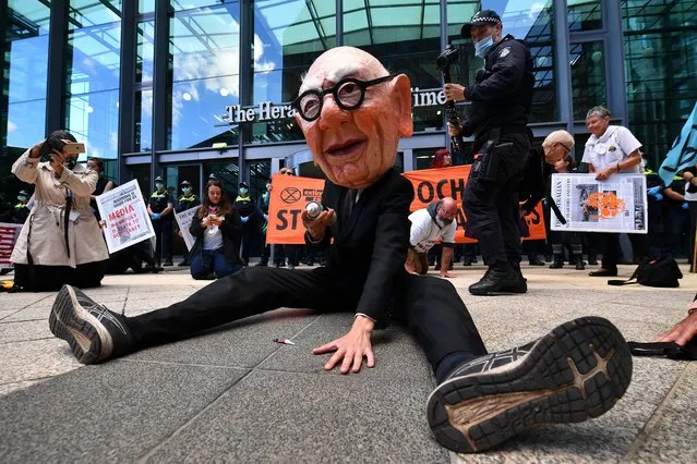 Protesters, including one dressed as Rupert Murdoch, are seen during an Extinction Rebellion environmental protest against Rupert Murdoch and News Corporation in Melbourne, Australia, 25 March 2021. (Photo by James Ross/EPA/EFE)